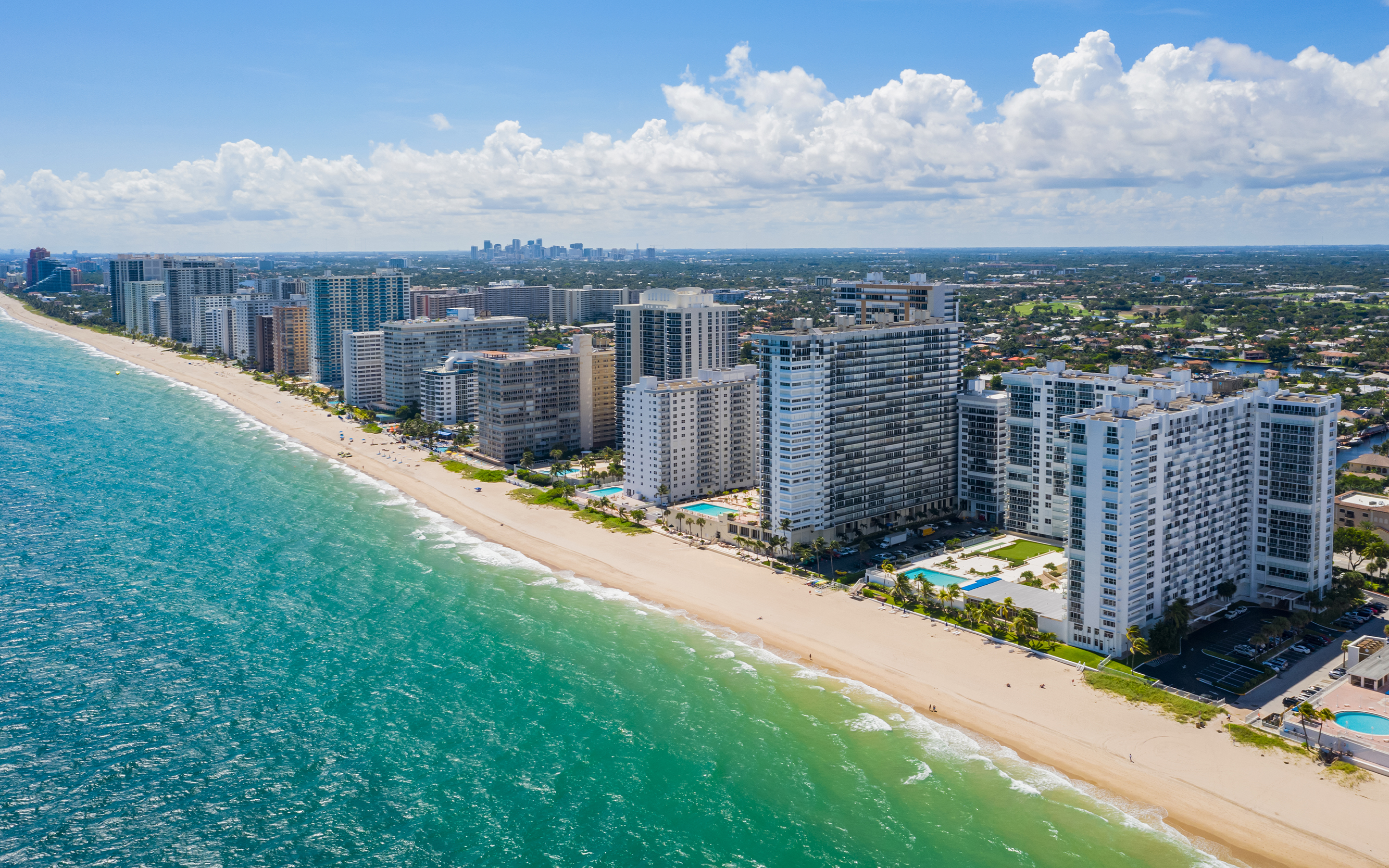 Aerial view of the Fort Lauderdale skyline with ocean, beach, and high-rise buildings