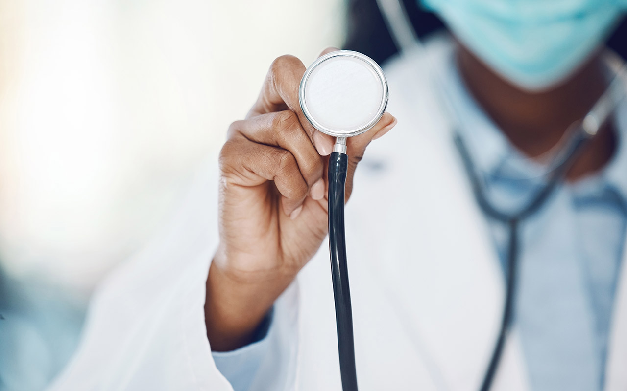 Closeup african american woman doctor standing with a stethoscope in the hospital.