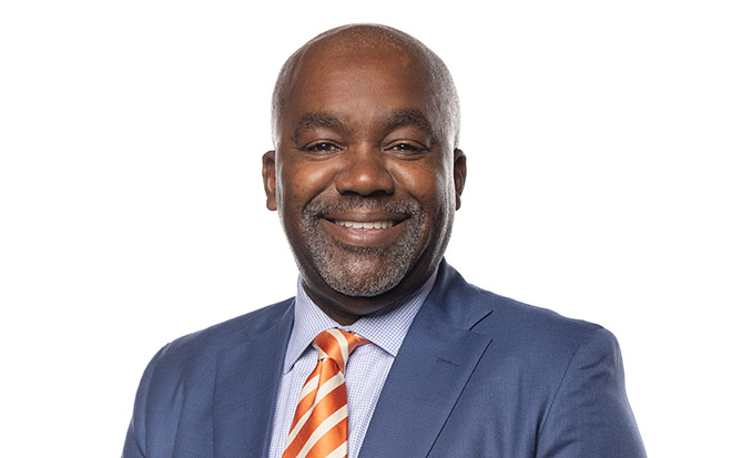 Baltimore partner Kraig Long poses for a headshot photo against a white background.