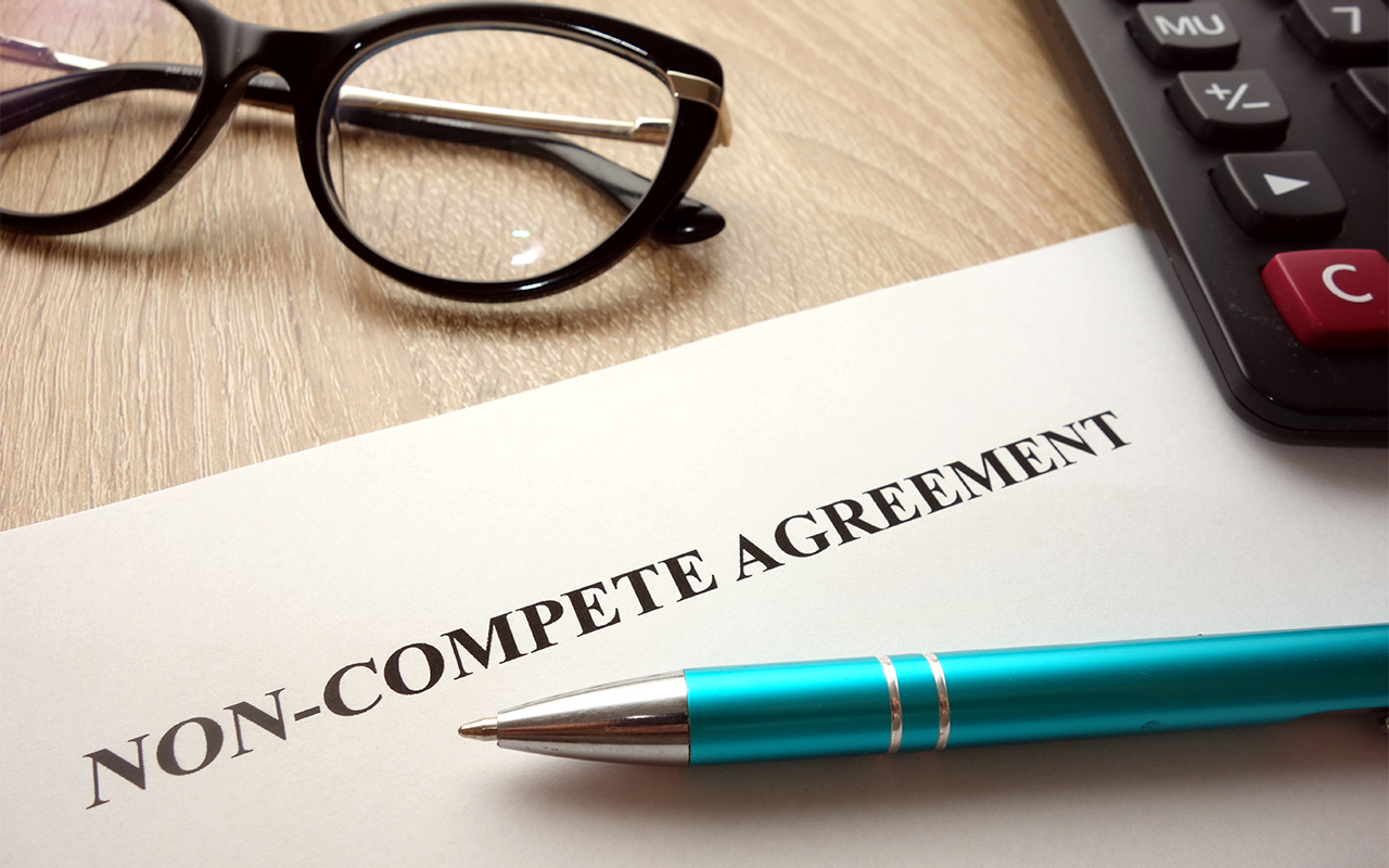 Non-compete agreement document for filling and signing on desk
