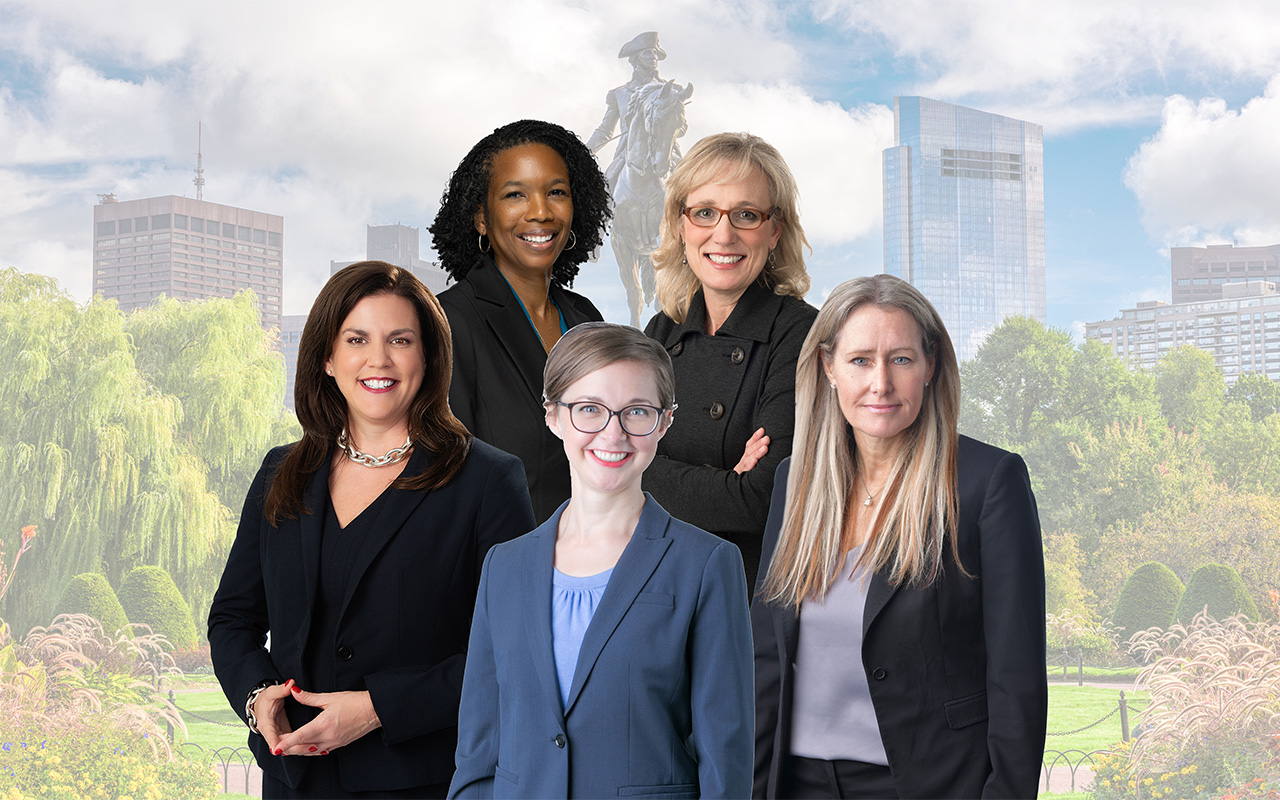 Five women standing in front of the city of Boston