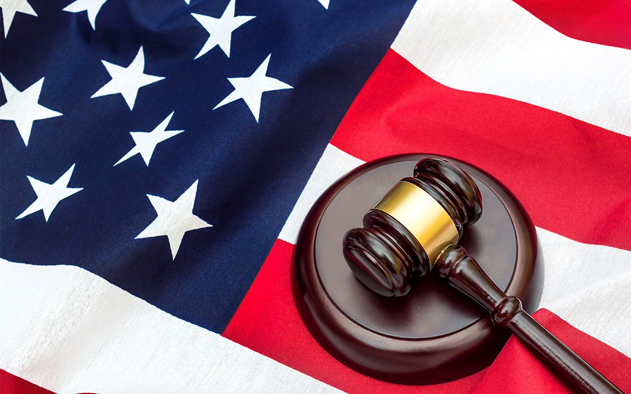 Gavel with stand on american flag.