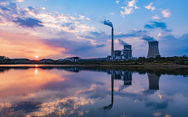 Nuclear power plant after sunset. Dusk landscape with big chimneys. - stock photo