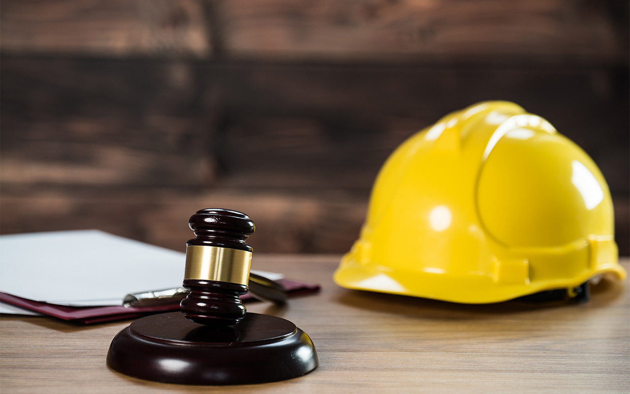 Photo of a judge's gavel and hard hat, illustrative of construction law