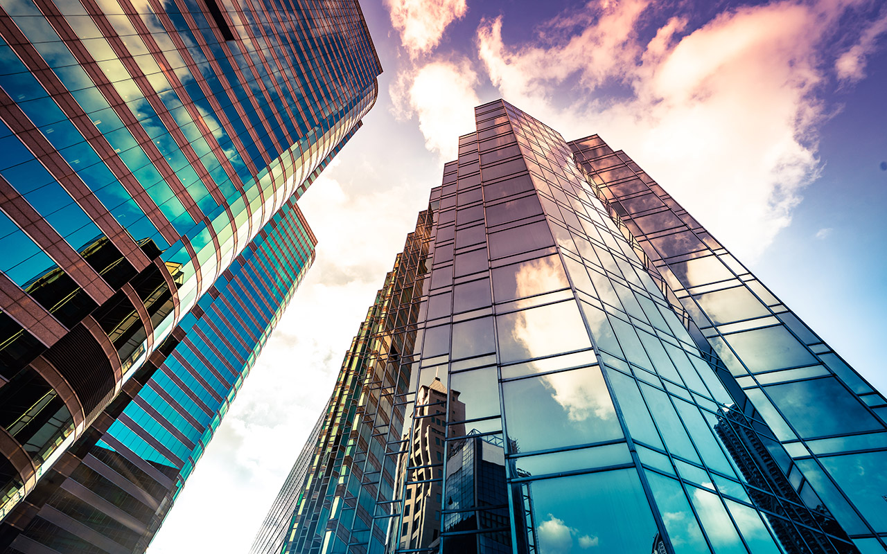 image Looking up at reflections on glass-covered corporate building