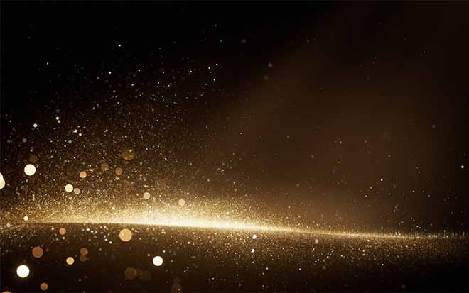 Image of golden light and glitter on a back background