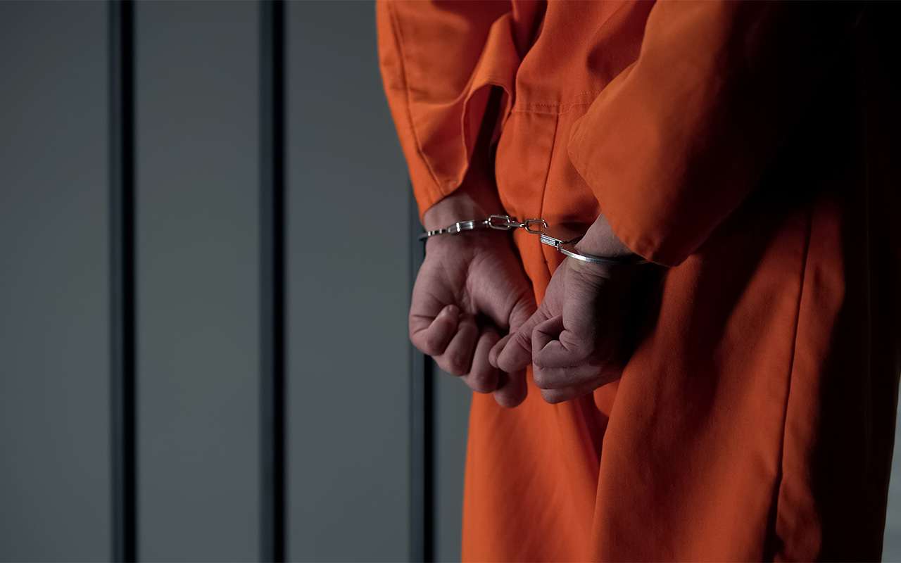 image of Prisoner with handcuffed arms behind back, another jail transfer, criminal