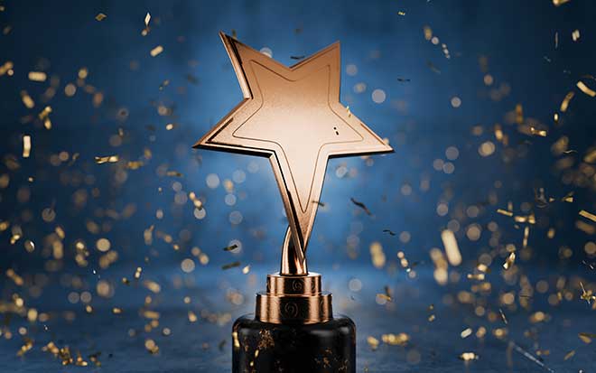 Gold star shaped trophy surrounded by gold confetti and a blue background