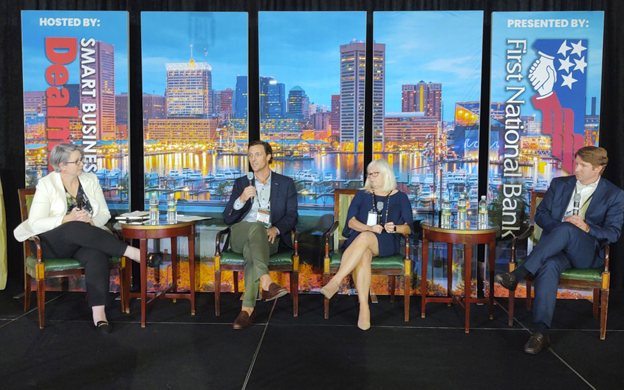 Partner Colleen Kline speaking on a panel with three other people.