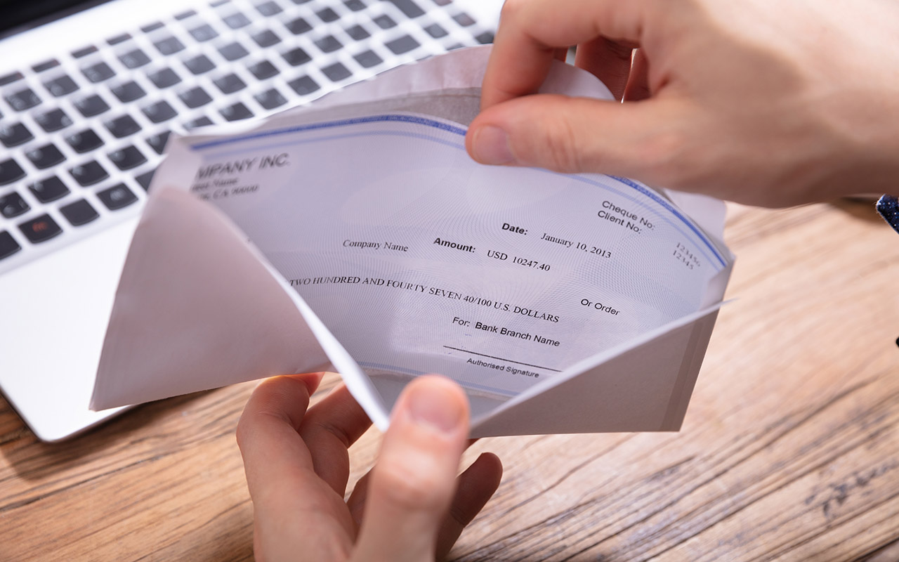 Image of a person opening an envelope