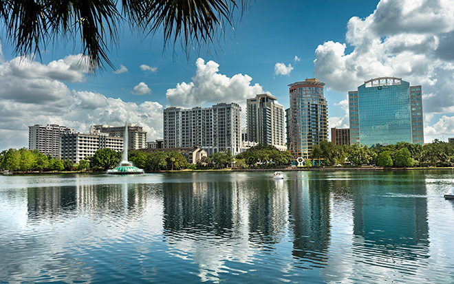 Orlando Florida city skyline over the waters of Lake Eola park in downtown
