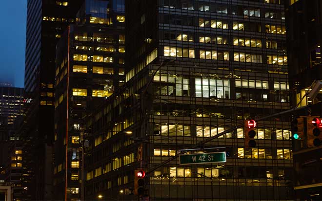 Large glass buildings lit up at night