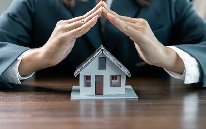 Lawyer against or real estate agent and real estate agent general liability insurance businesswoman professional discussing and consultant with house toy model building, protect your house and building