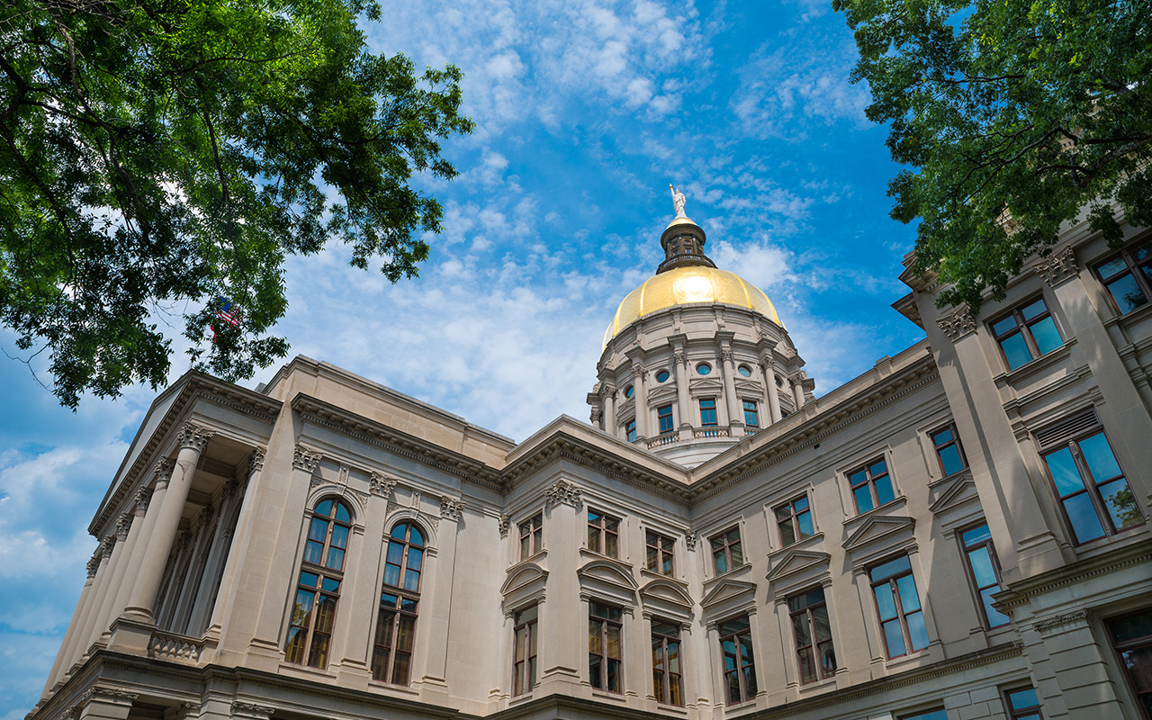 Image of Georgia state capitol building in Atlanta under cloudy blue sky