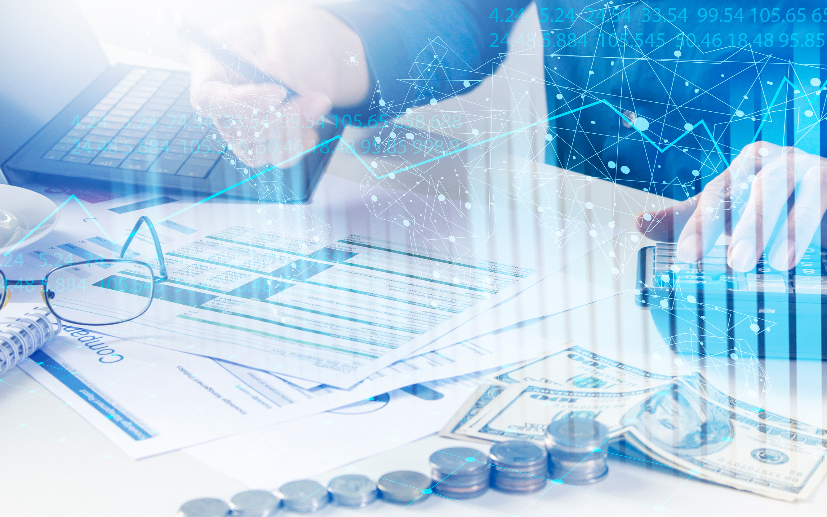 A table with money, glasses and spreadsheets scattered across it as someone works on a project.