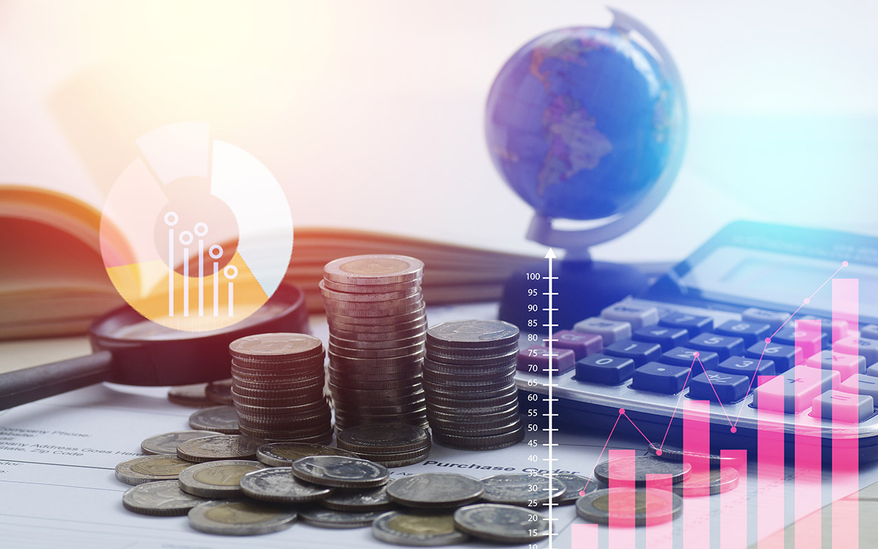 Image of coins, a calculator, and globe on a desk