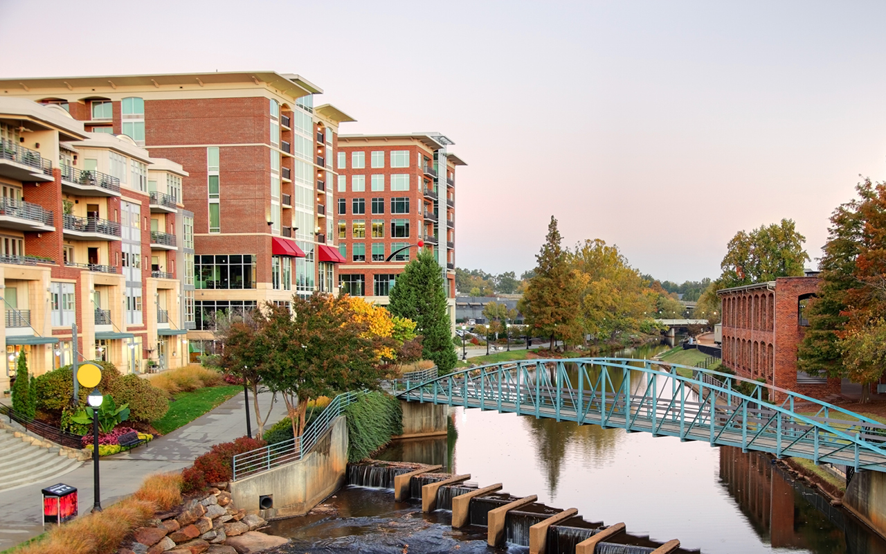 Downtown Greenville is pictured against a setting sun.