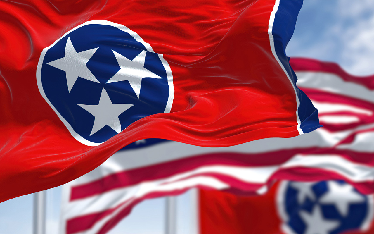 Two Tennessee state flags waving with the national flag of the United States of America in the middle
