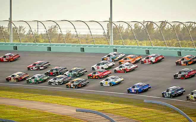 Image of stock cars racing around a track