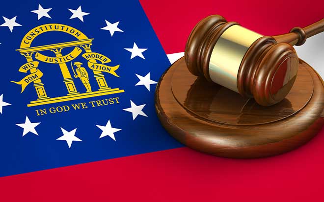 legal gavel sitting on top of a red, white, and blue flag