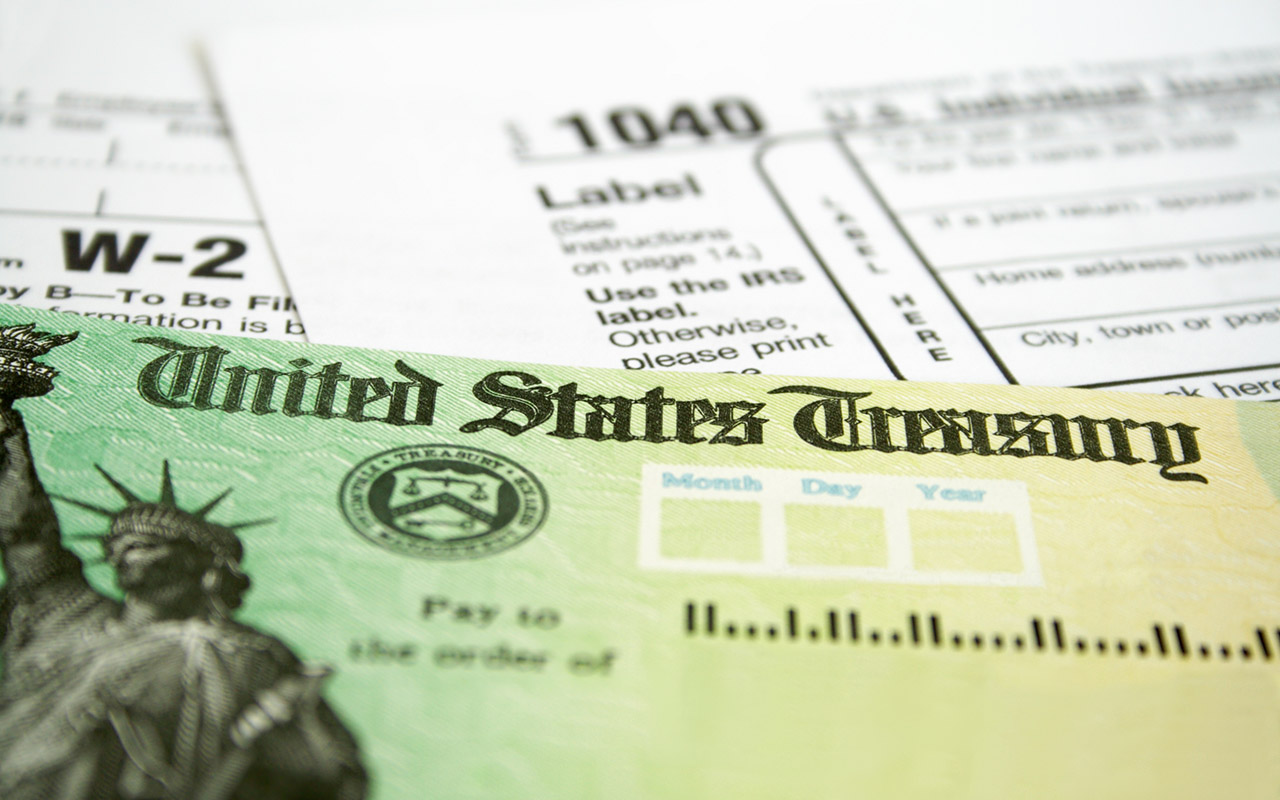 Tax Refund Check with W-2 and 1040 U.S. Individual Income Tax Return Forms