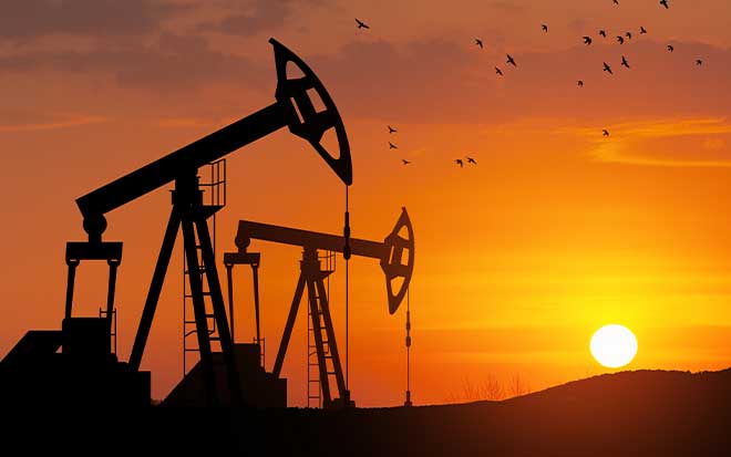 oil rigs and machinery at sunset