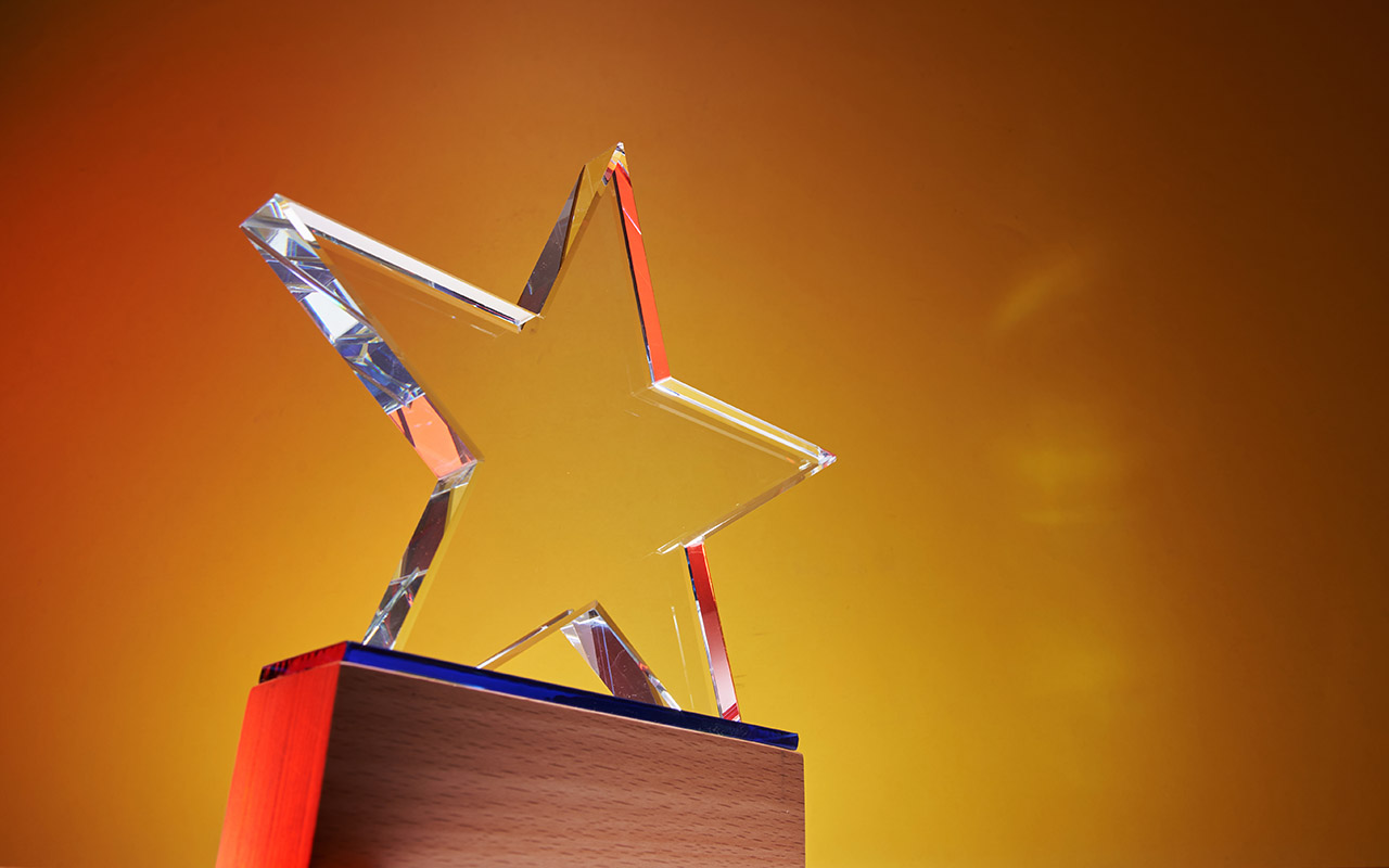 Image of a Lucite star on a wooden pedestal