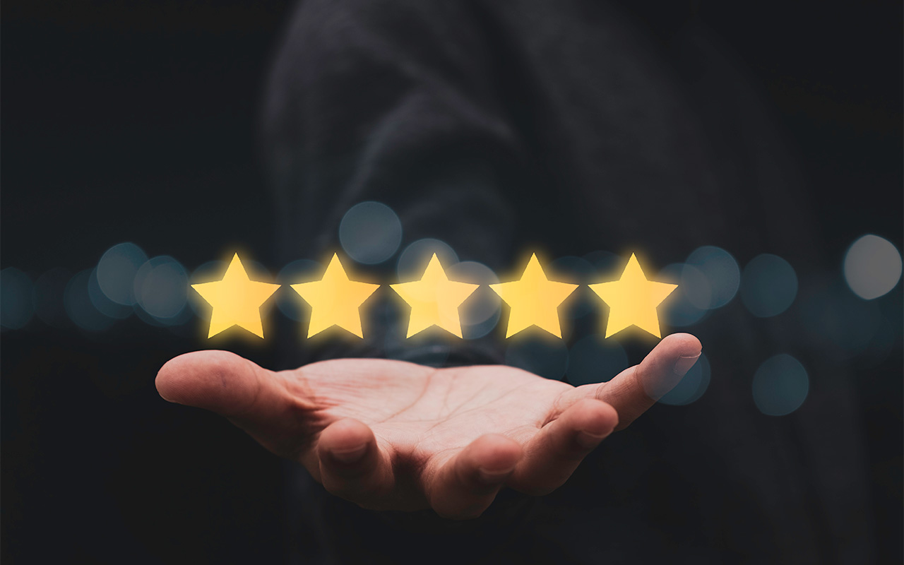 Businessman showing five star on hand for customer evaluation result.
