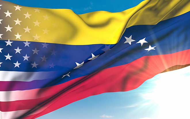 american flag overlapping venezuela flag against sky