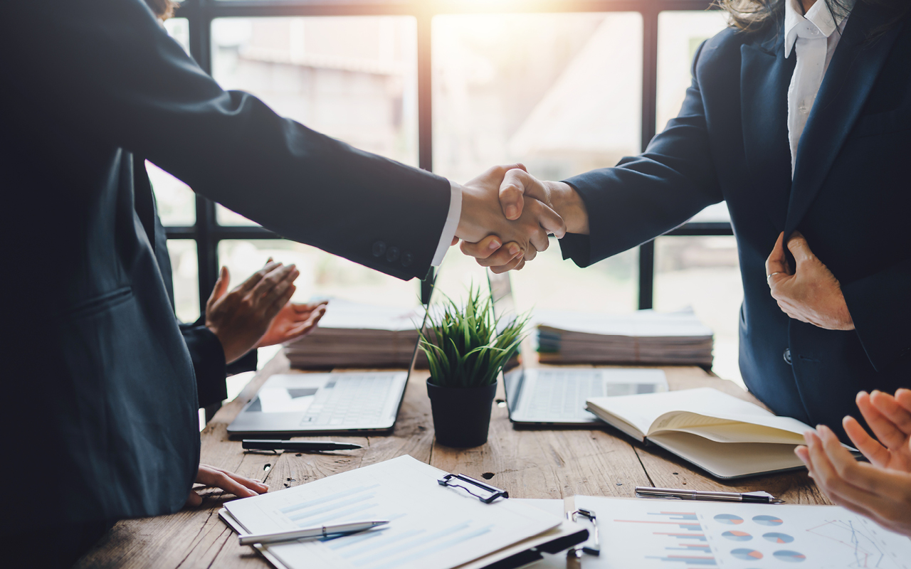Two business men shaking hands.