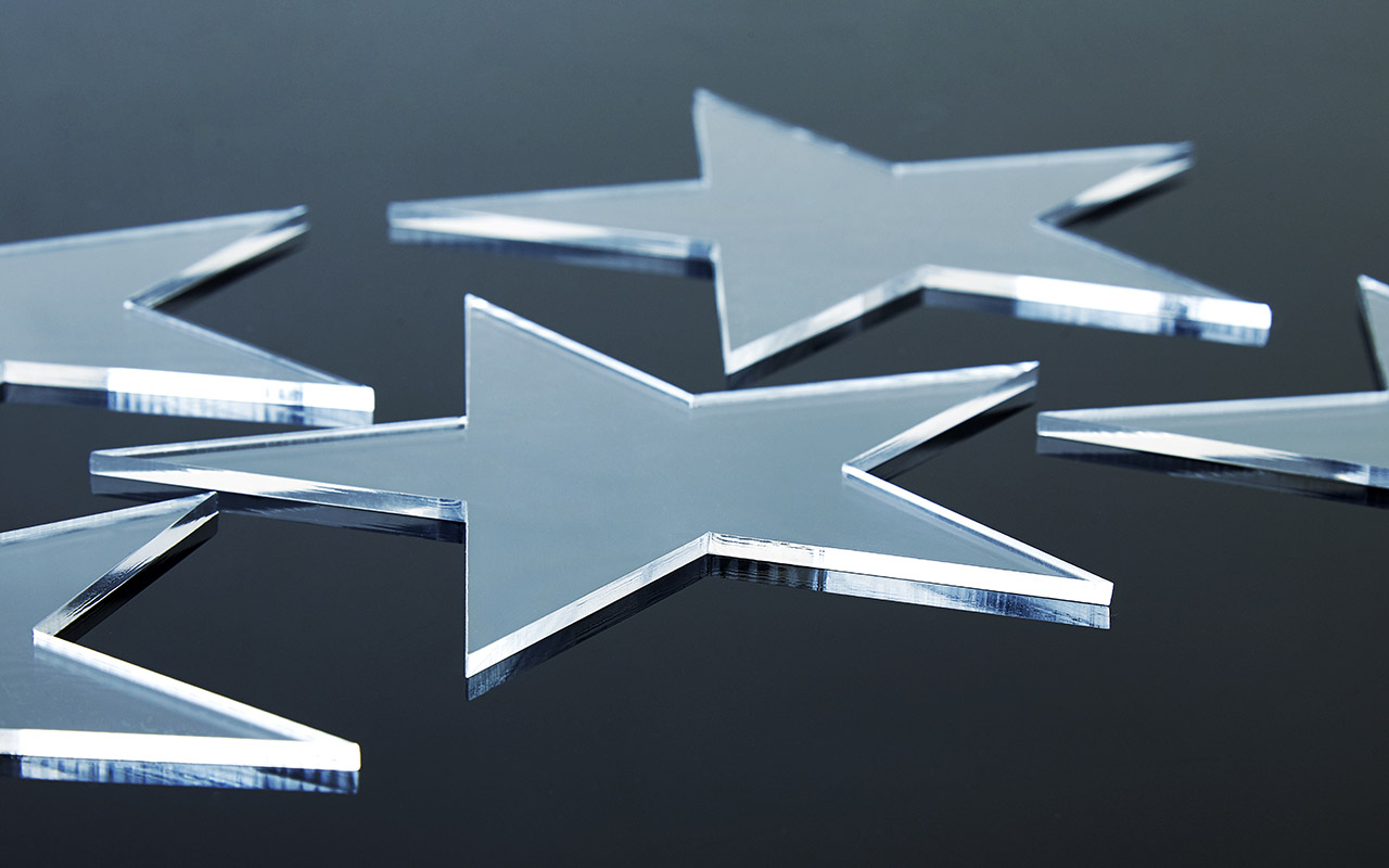Glass star shapes on black background