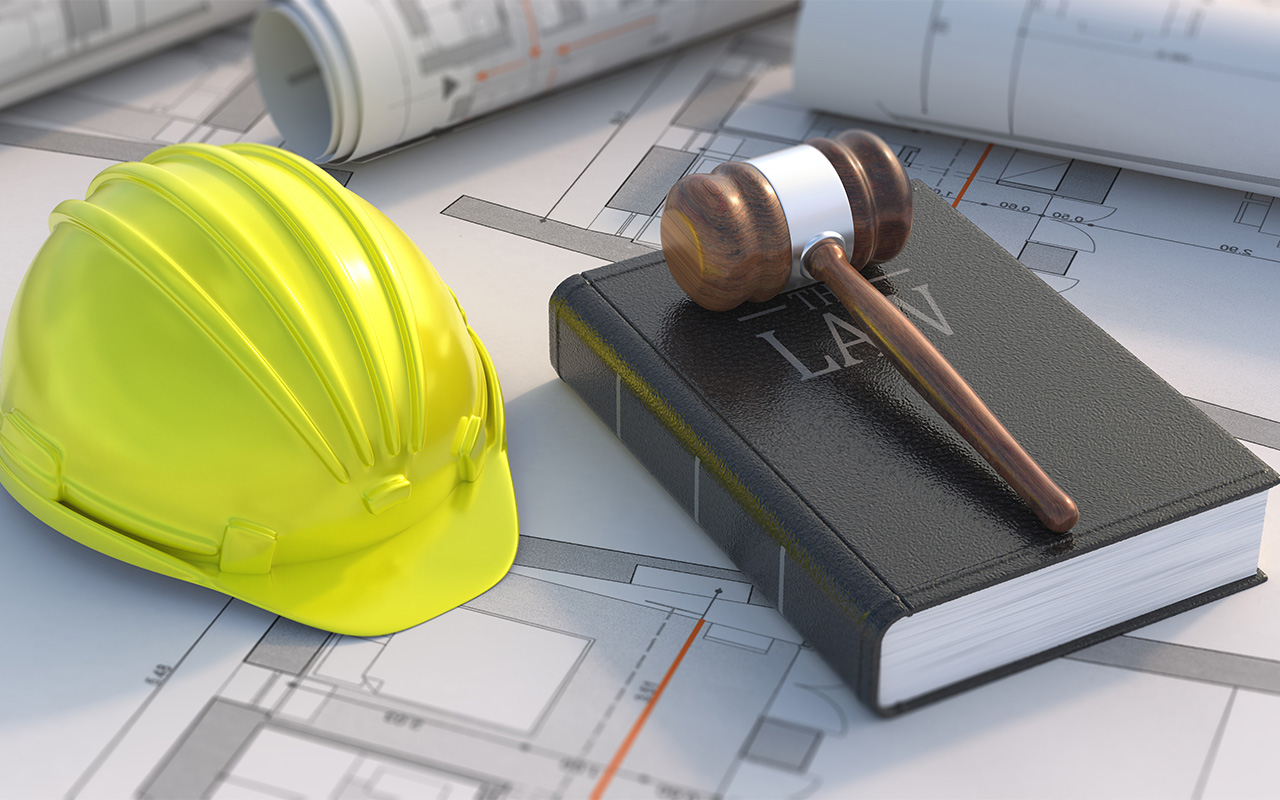 Judge gavel hardhat and black book on project blueprint background
